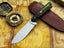 UA Forest Ranger hunting knife with an 11-inch hand-forged blade and G10 Micarta handle, ideal for camping and outdoor tasks.