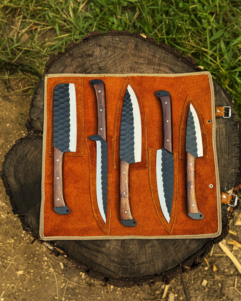 UA Sakura Forge handmade 5-piece Damascus steel chef set with leather storage bag, featuring knives with elegant patterned blades.