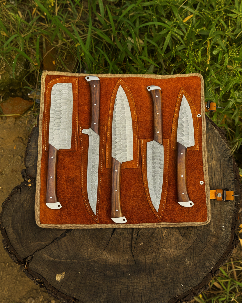 UA Knives Nile Forge hand-forged carbon steel chef set with five knives in a leather carry bag.