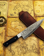 Hand forged Damascus steel chef knife by UA Knives with full tang, lightweight design, and protective sheath for professional cooking.
