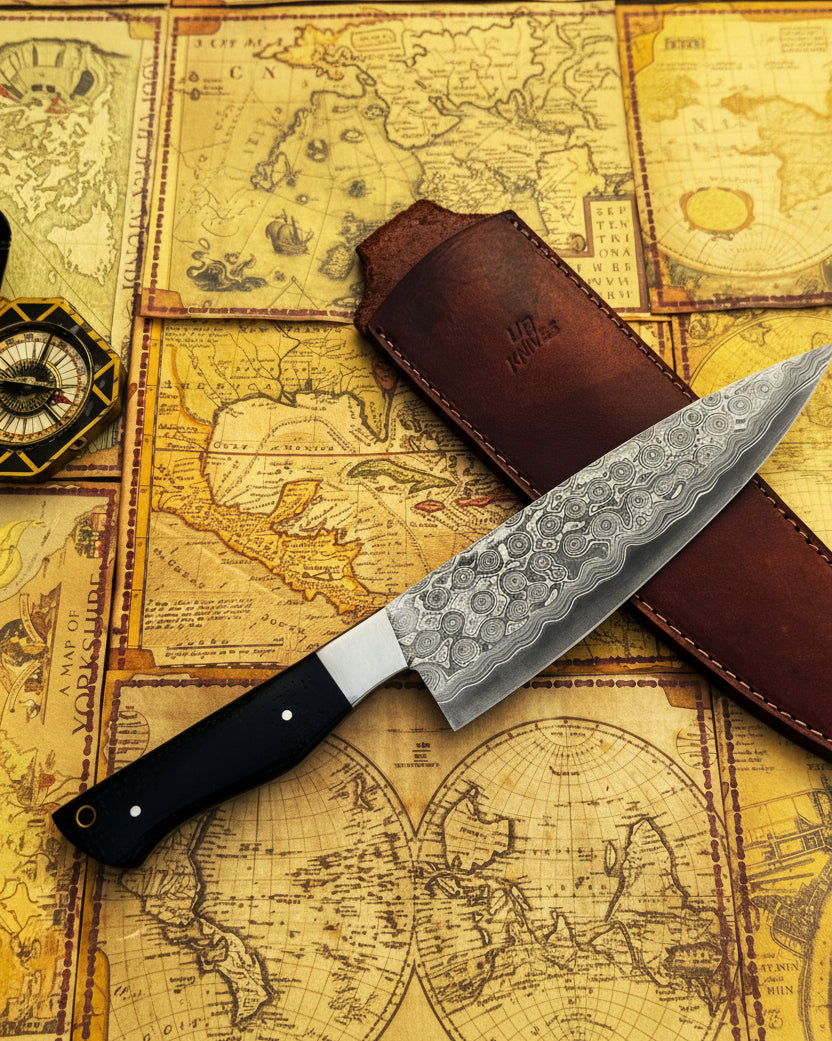 Hand forged Damascus steel chef knife by UA Knives with full tang, lightweight design, and protective sheath for professional cooking.