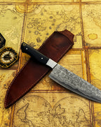 UA Knives hand-forged Damascus steel chef knife with full tang and sheath, lightweight and professional for precise kitchen cutting.