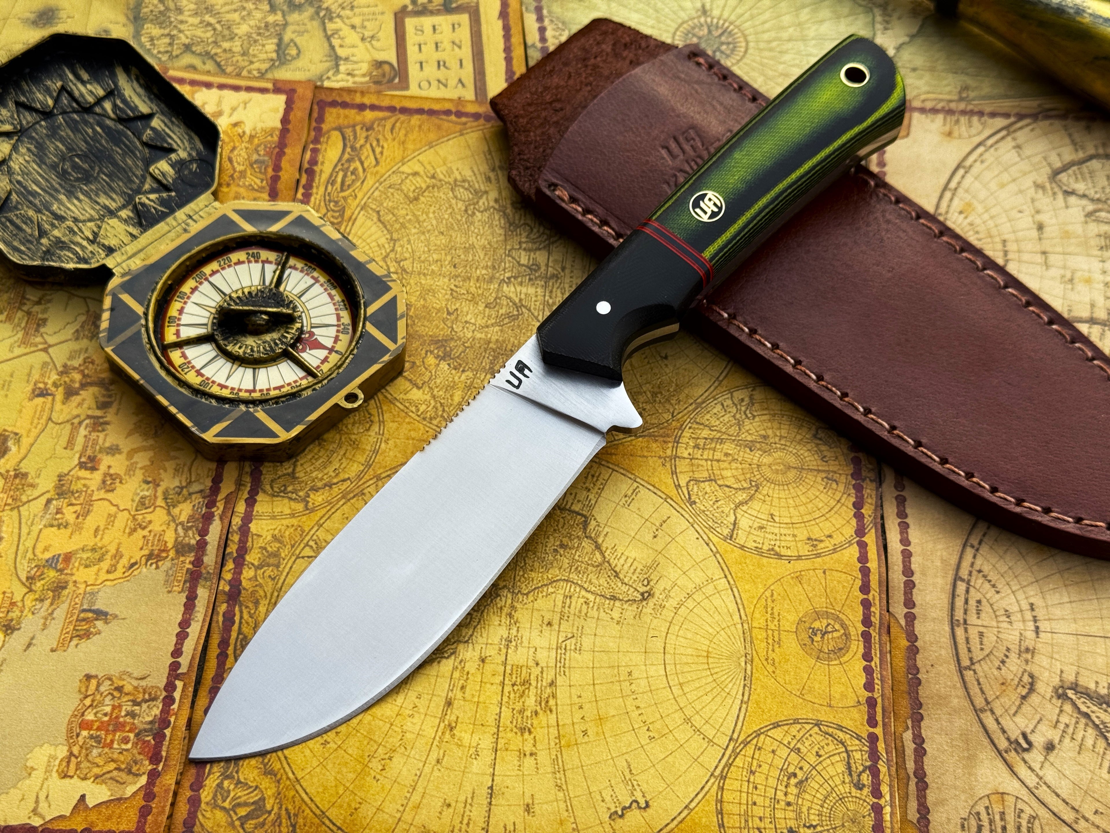 UA Forest Ranger hunting knife with an 11-inch hand-forged blade and G10 Micarta handle, ideal for camping and outdoor tasks.