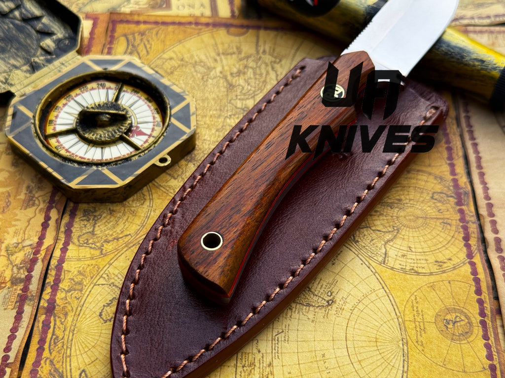 UA Cobra Strike camping knife by UA Knives with handmade lightweight design and sheath, displayed on a neutral background.