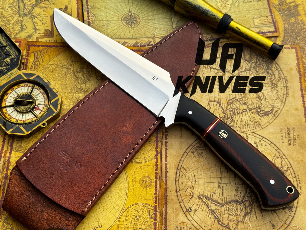 UA Knives Dragons Tooth handmade Bowie hunting knife with leather sheath, featuring a detailed blade and sturdy handle.