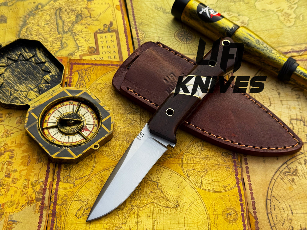 UA Silver Myst stainless steel camping skinning knife with sheath, featuring a sleek blade and ergonomic handle for outdoor use