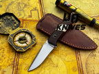 UA Silver Myst stainless steel camping skinning knife with sheath, featuring a sleek blade and ergonomic handle for outdoor use