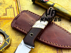 UA Silver Myst stainless steel camping skinning knife with sheath, featuring a sharp blade and ergonomic handle for outdoor use.
