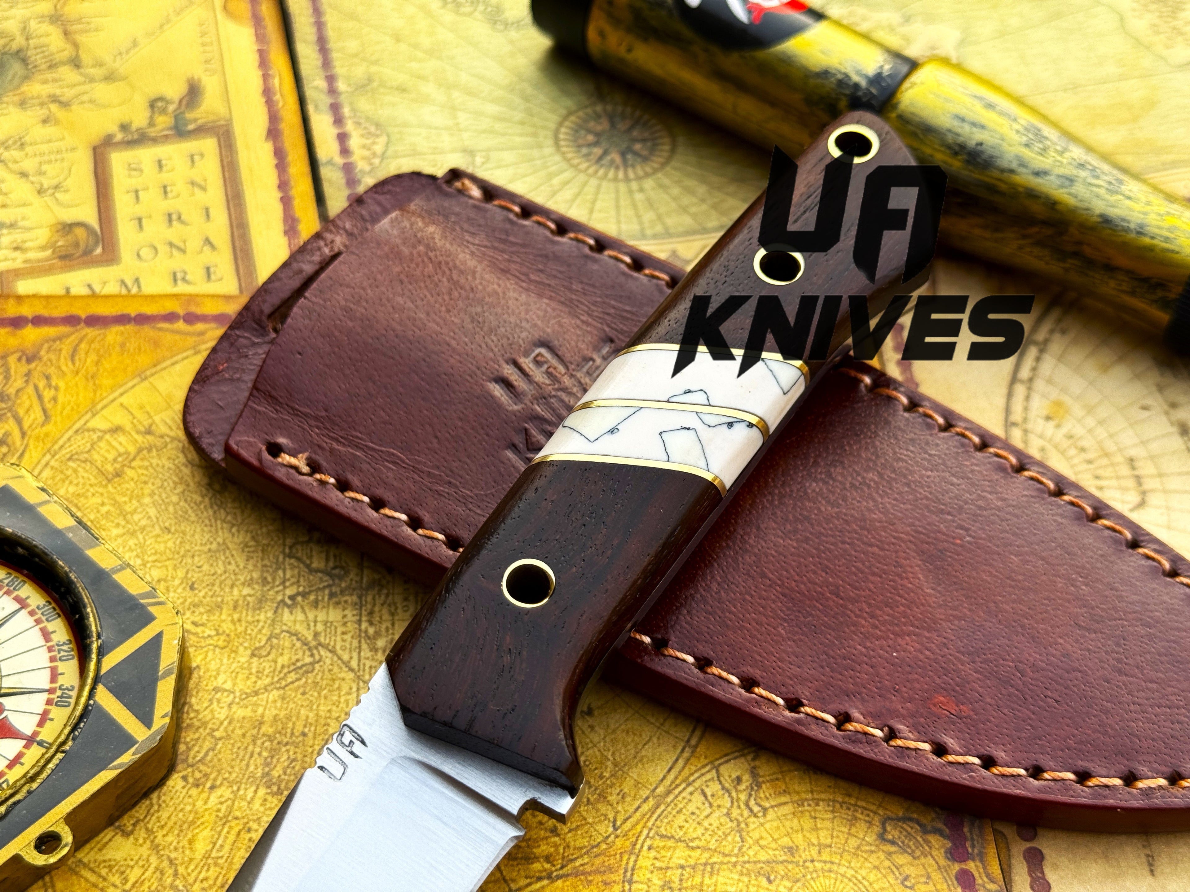 UA Silver Myst stainless steel camping skinning knife with sheath, featuring a sharp blade and ergonomic handle for outdoor use.
