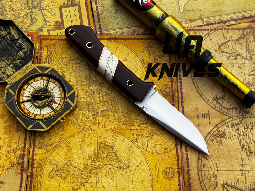 UA Knives Silver Myst stainless steel camping skinning knife with sheath, featuring a sharp blade and ergonomic handle.