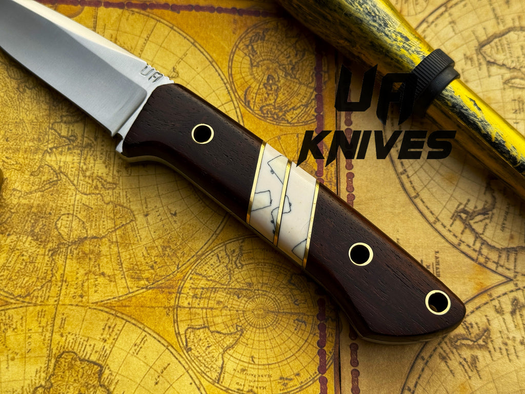 UA Silver Myst stainless steel camping skinning knife with sheath, outdoor hunting tool by UA Knives displayed on a white background.