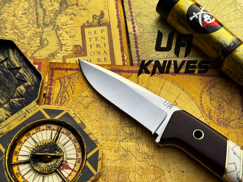 UA Silver Myst stainless steel camping skinning knife with sheath, featuring a sharp blade and durable handle for outdoor use.
