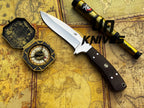 UA Knives Bear Claw hunting knife with hand-forged blade and G10 Micarta handle, displayed on a wooden surface.