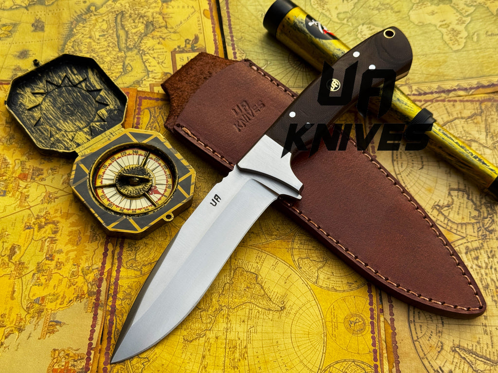 UA Knives Bear Claw hunting knife with hand-forged blade and G10 Micarta handle, displayed on a wooden surface.