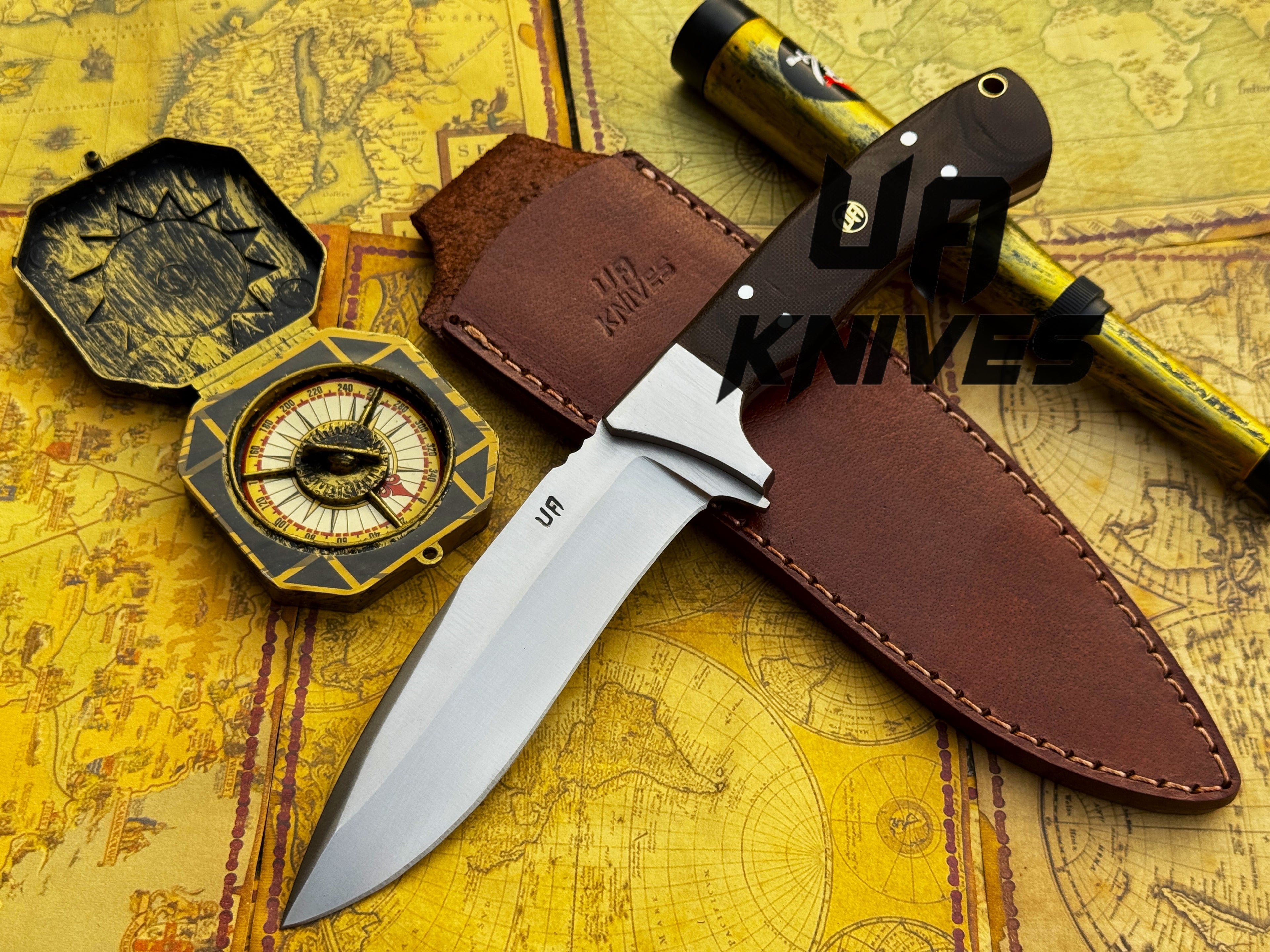 UA Knives Bear Claw hunting knife with hand-forged blade and G10 Micarta handle, displayed on a wooden surface.