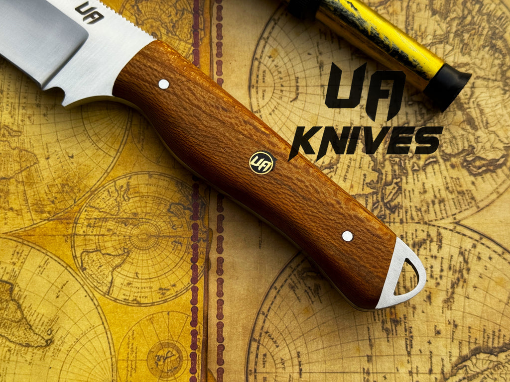 UA Nature Nook hand-forged stainless steel hunting knife with a textured handle and sharp blade, designed for outdoor hunting activities.