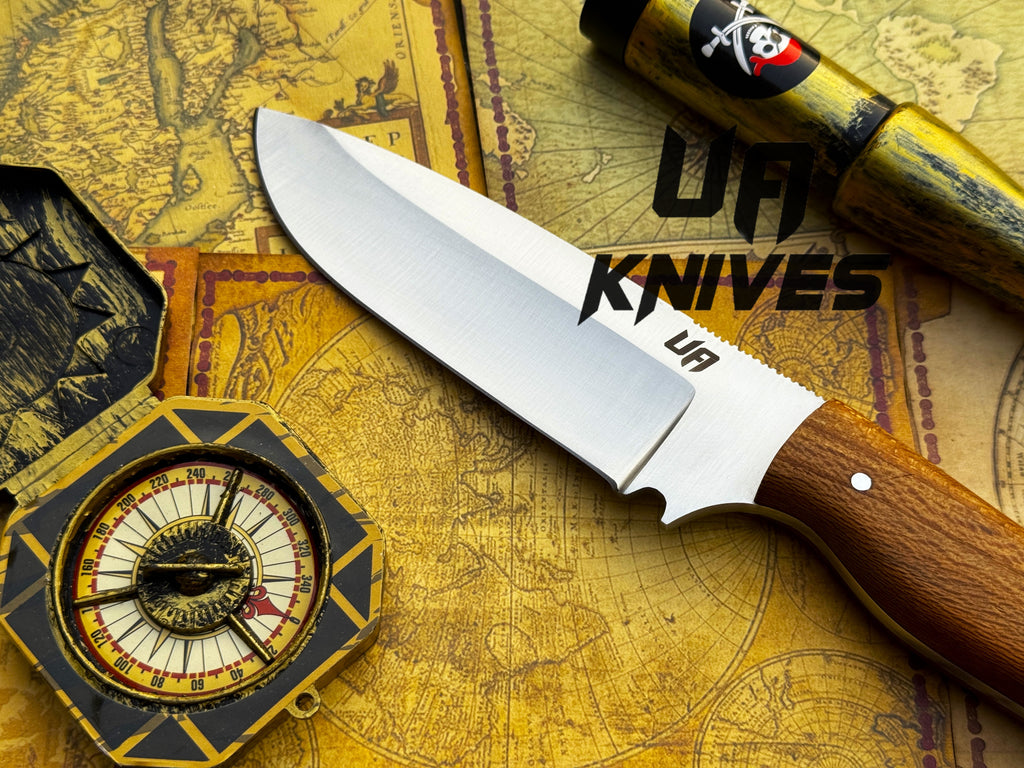 UA Knives UA Nature Nook hand-forged stainless steel hunting knife with a textured handle and sharp blade.
