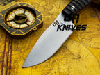 UA Knives Silver Myst hunting knife with hand-forged 12C27 blade and sheath, featuring a sleek silver handle and sturdy design.