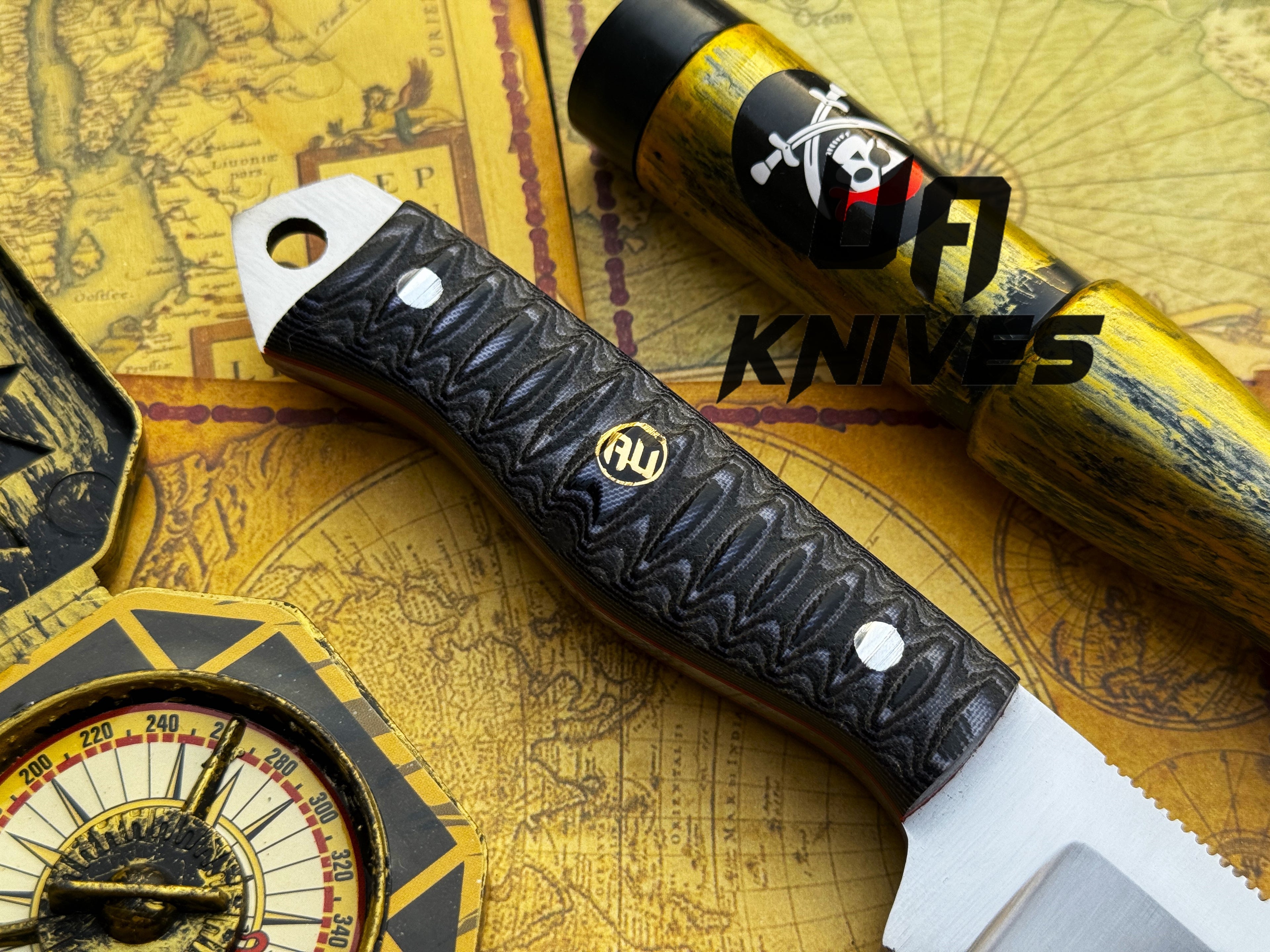UA Silver Myst hunting knife by UA Knives, hand-forged 12C27 blade with leather sheath, displayed on a wooden surface.