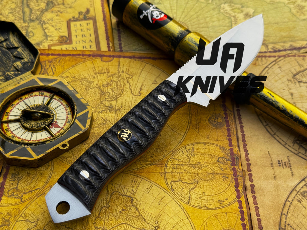 UA Silver Myst hunting knife by UA Knives, hand forged 12C27 steel with a sheath, featuring a sturdy blade and ergonomic handle.