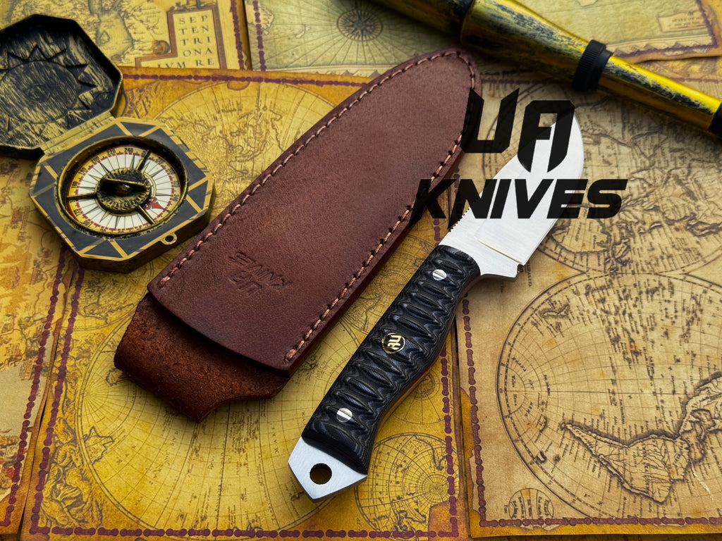 UA Knives Silver Myst camping knife with hand-forged 12C27 blade and sheath, ideal for hunting and outdoor tasks.