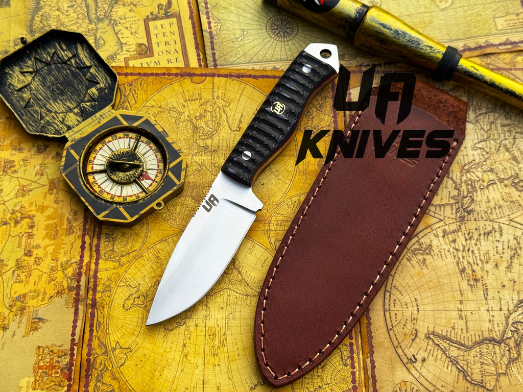 UA Silver Myst hunting knife by UA Knives, hand-forged 12C27 stainless steel with leather sheath, displayed on a neutral background.