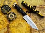 UA Night Stalker hunting knife with 12C27 stainless steel blade and black handle, displayed on a wooden surface.