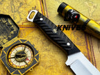 UA Night Stalker hunting knife with 12C27 stainless steel blade and black handle, displayed on a wooden surface.