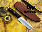 UA Night Stalker hunting knife with 12C27 stainless steel blade and ergonomic handle, displayed on a neutral background.