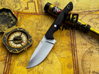 UA Oakheart handmade survival and bushcraft camping knife with wooden handle and sharp blade, displayed on a wooden surface.