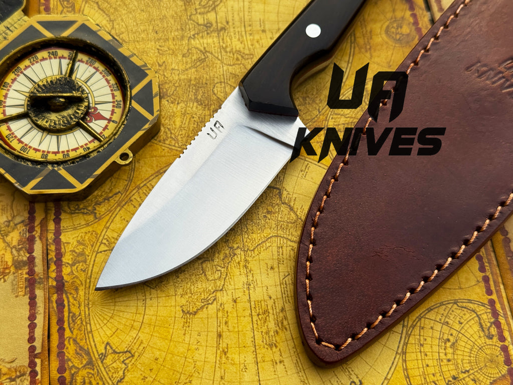 UA Oakheart handmade survival and bushcraft camping knife with a wooden handle and sharp blade, designed for outdoor use.