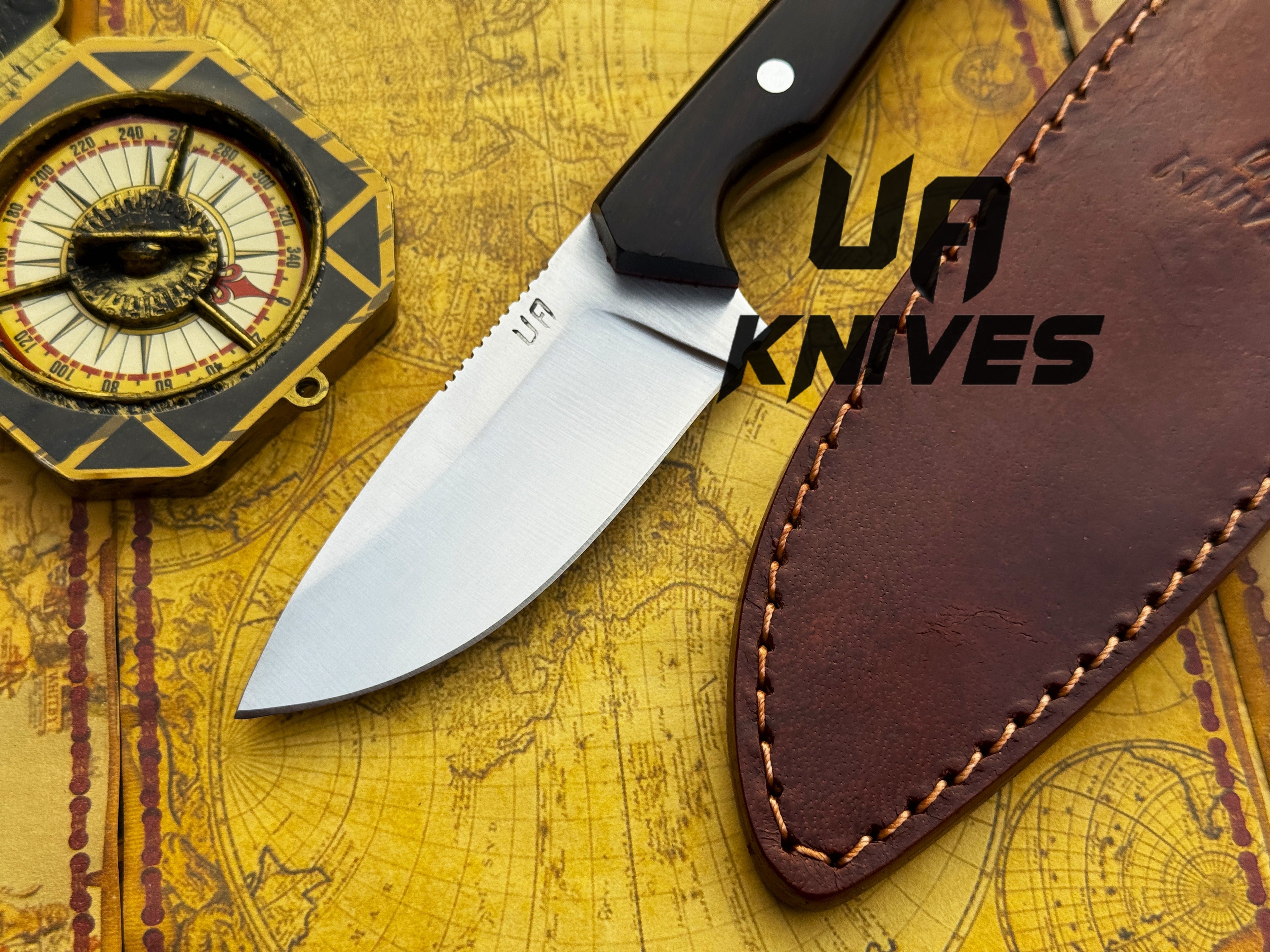 UA Oakheart handmade survival and bushcraft camping knife with a wooden handle and sharp blade, designed for outdoor use.