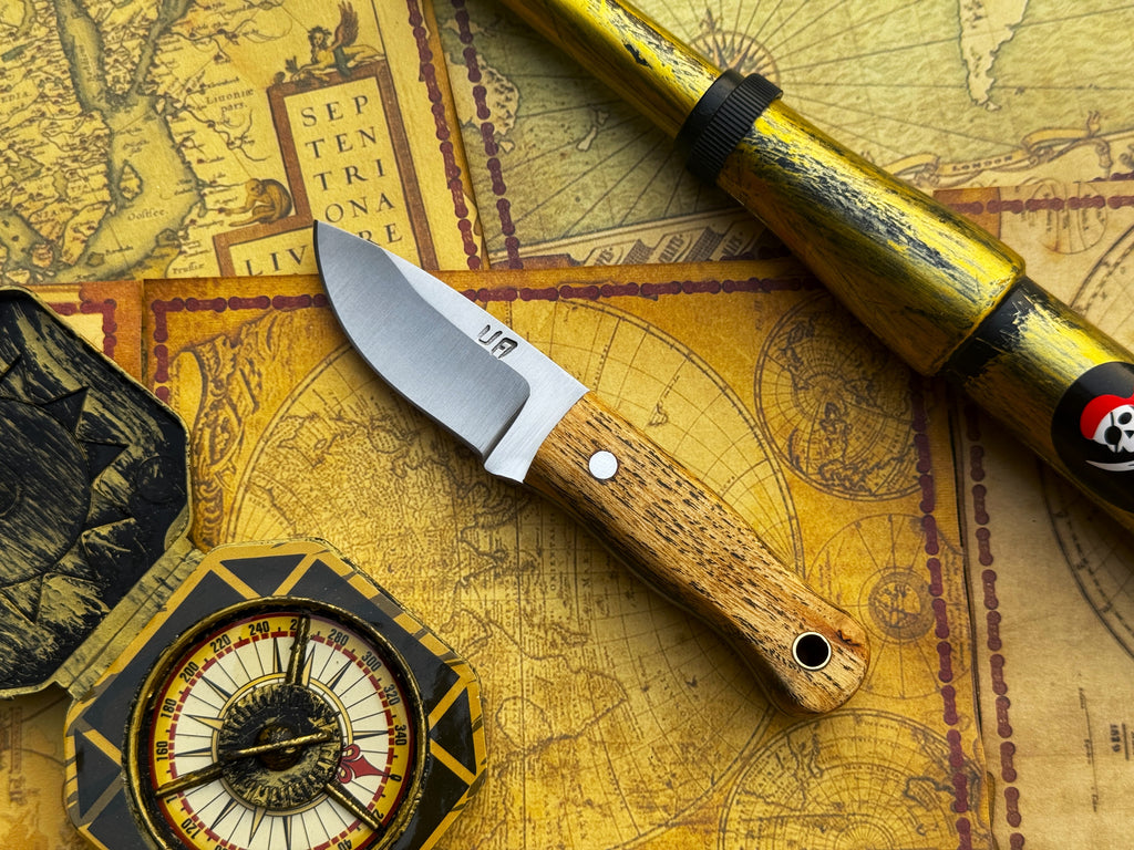 UA Devil Dust handmade EDC utility knife with a sleek blade and ergonomic handle, designed for everyday carry and utility tasks.
