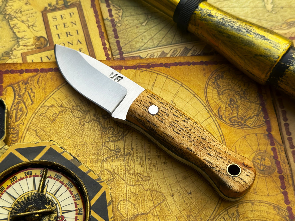 UA Devil Dust handmade EDC utility knife with textured handle and sharp blade, designed for everyday carry and versatile use.
