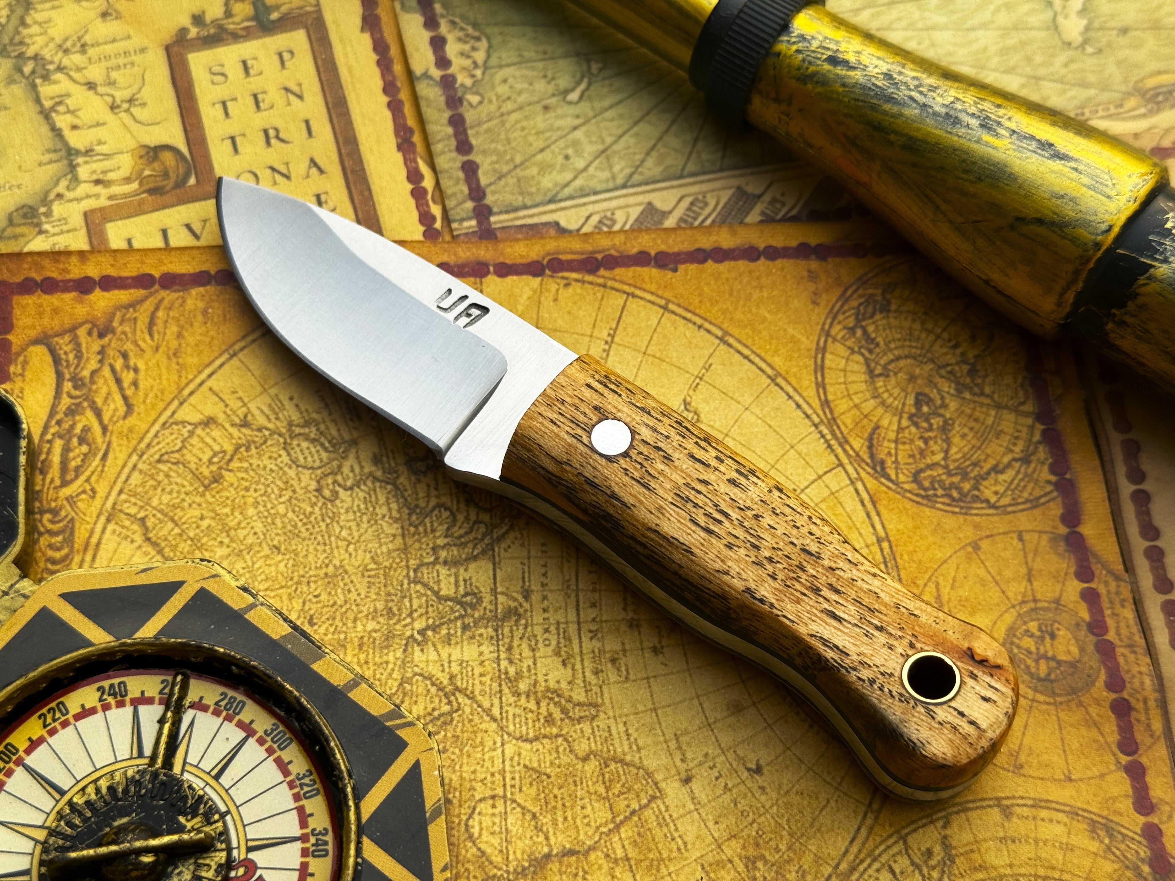 UA Devil Dust handmade EDC utility knife with textured handle and sharp blade, designed for everyday carry and versatile use.