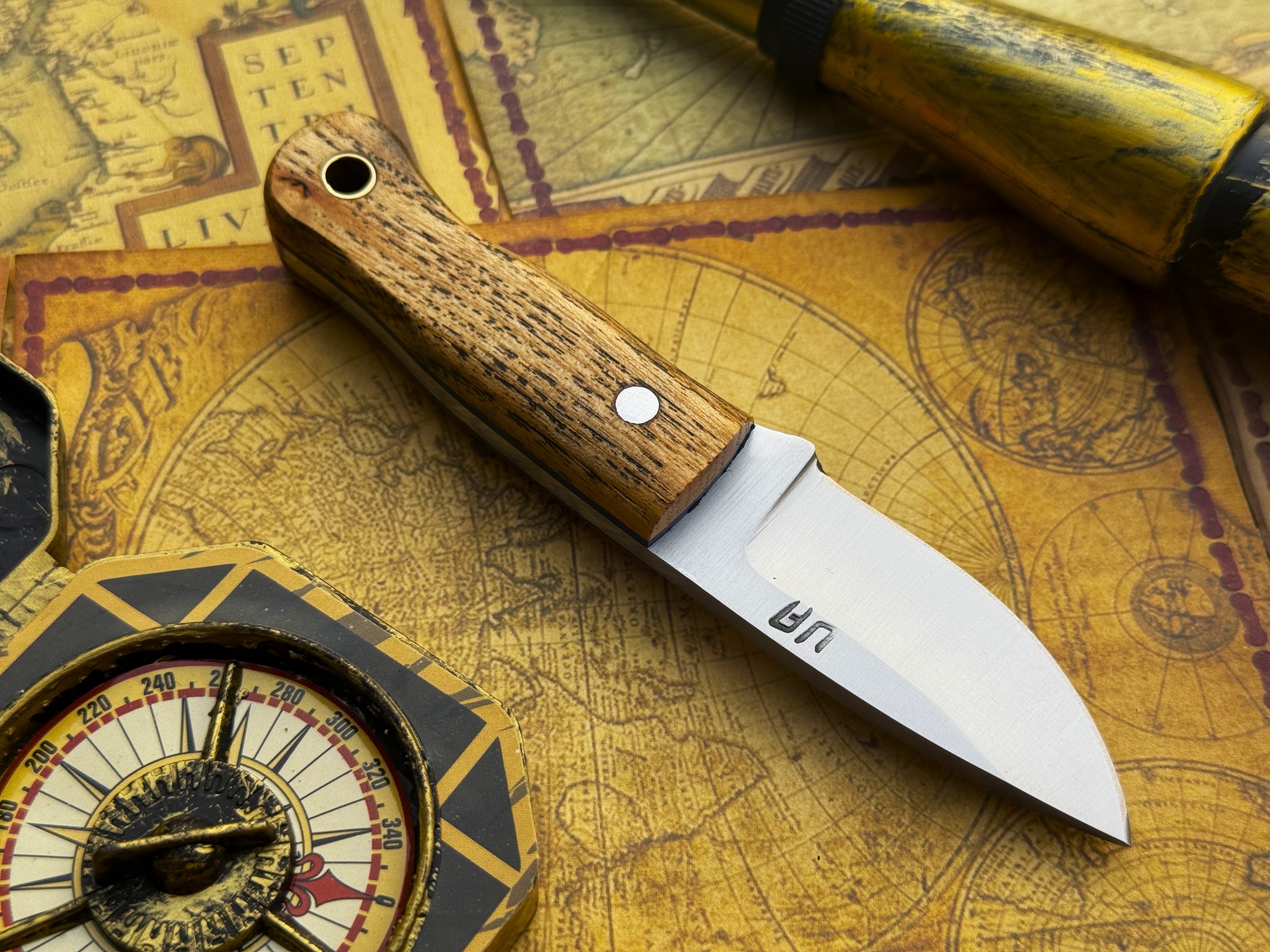 UA Devil Dust handmade EDC utility knife with a sleek blade and durable handle, designed for everyday carry and practical use.