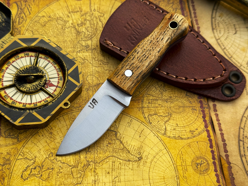UA Devil Dust handmade EDC utility knife with textured handle and sharp blade, designed for everyday carry and versatile use.