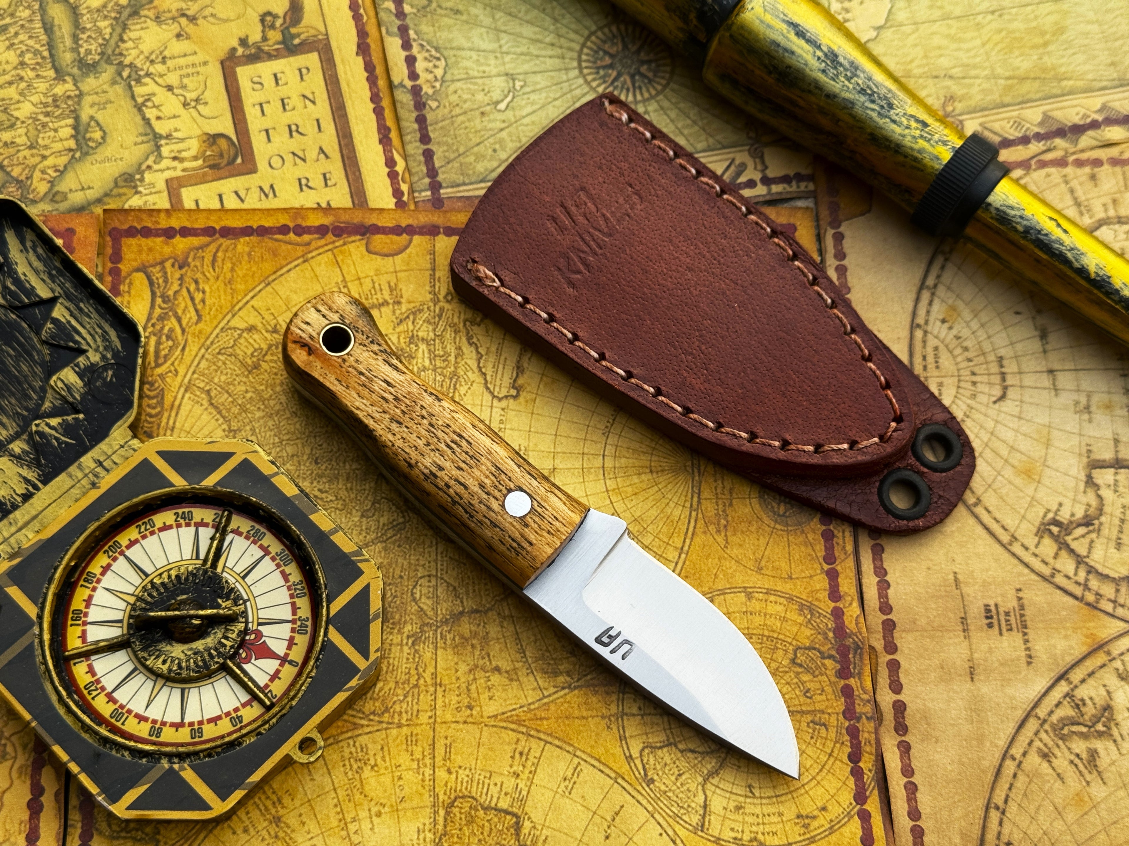 UA Devil Dust handmade EDC utility knife with a sleek blade and textured handle, designed for everyday carry and versatile use.