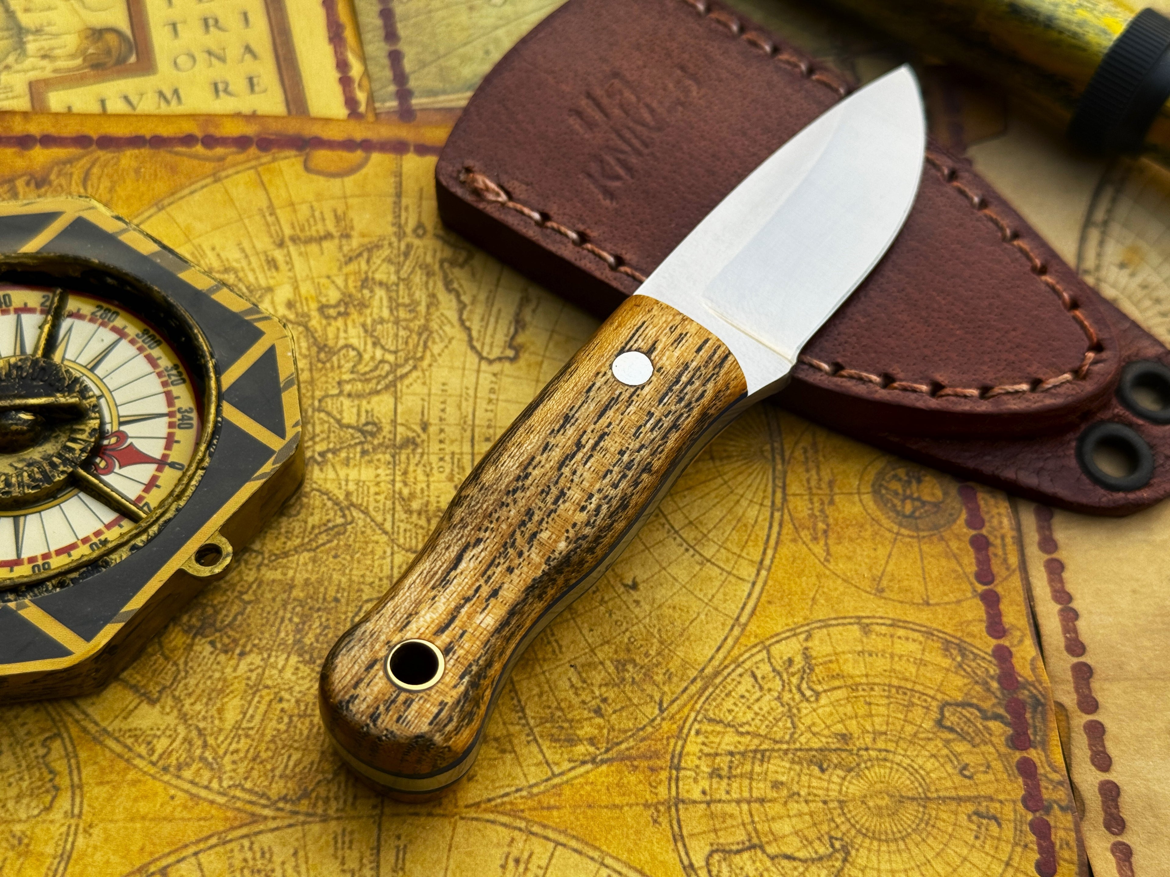 UA Devil Dust handmade EDC utility knife from UA Knives, featuring a sleek blade and ergonomic handle for everyday carry.