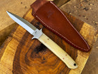 UA Knives Iron Fang stainless steel camping knife with a textured handle and sharp blade, ideal for outdoor camping and survival.