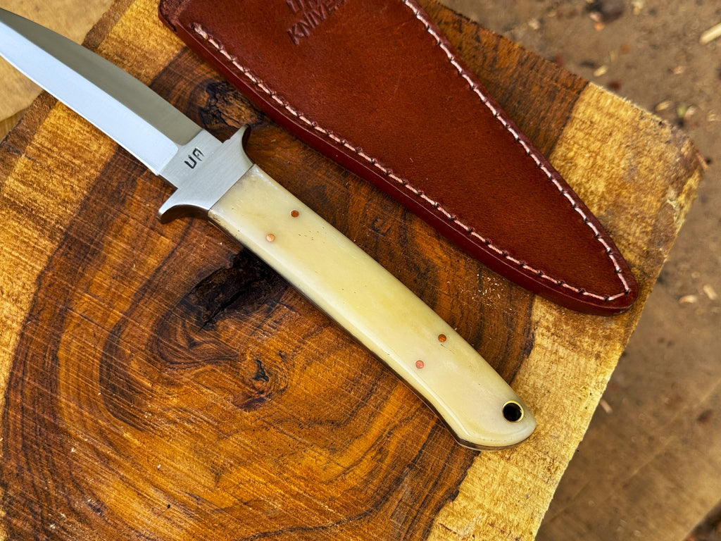 UA Iron Fang stainless steel camping knife with a textured handle and sharp blade, ideal for outdoor camping and survival tasks.