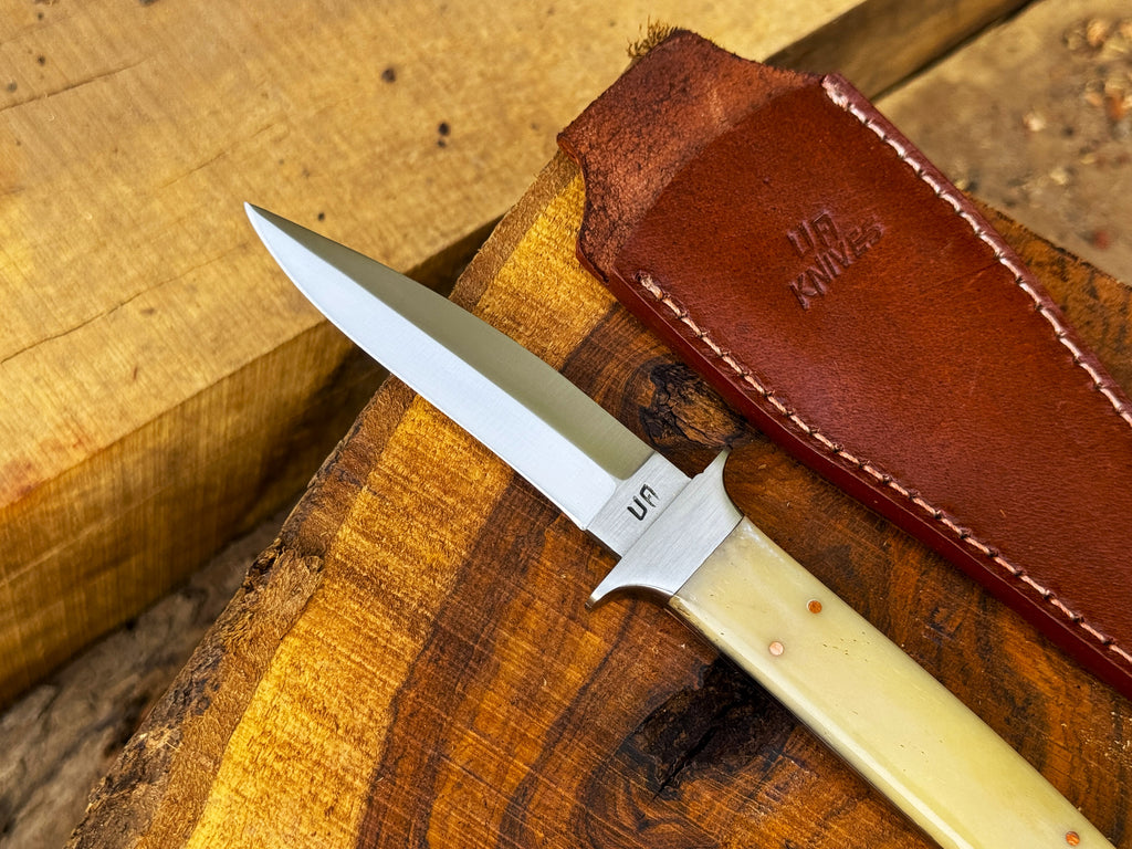 UA Iron Fang stainless steel camping knife with a textured handle and sharp blade, ideal for outdoor camping and survival tasks.