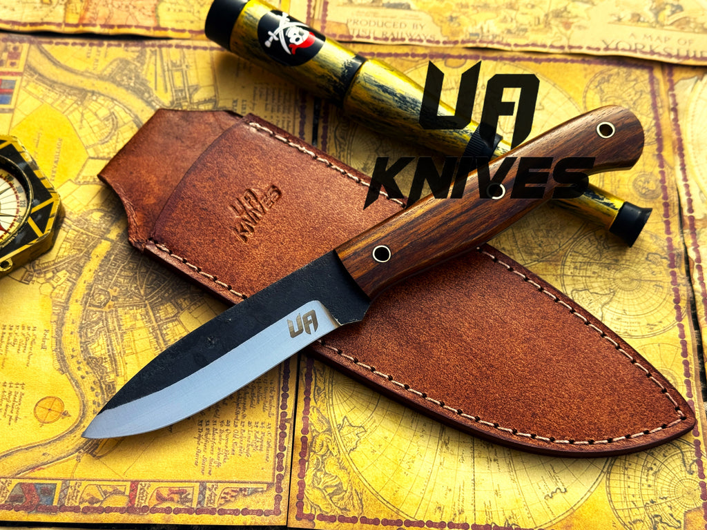 UA Knives True Guide camping knife with hand-forged Scandinavian blade and ergonomic rosewood handle, ideal for bushcraft and camping tasks.