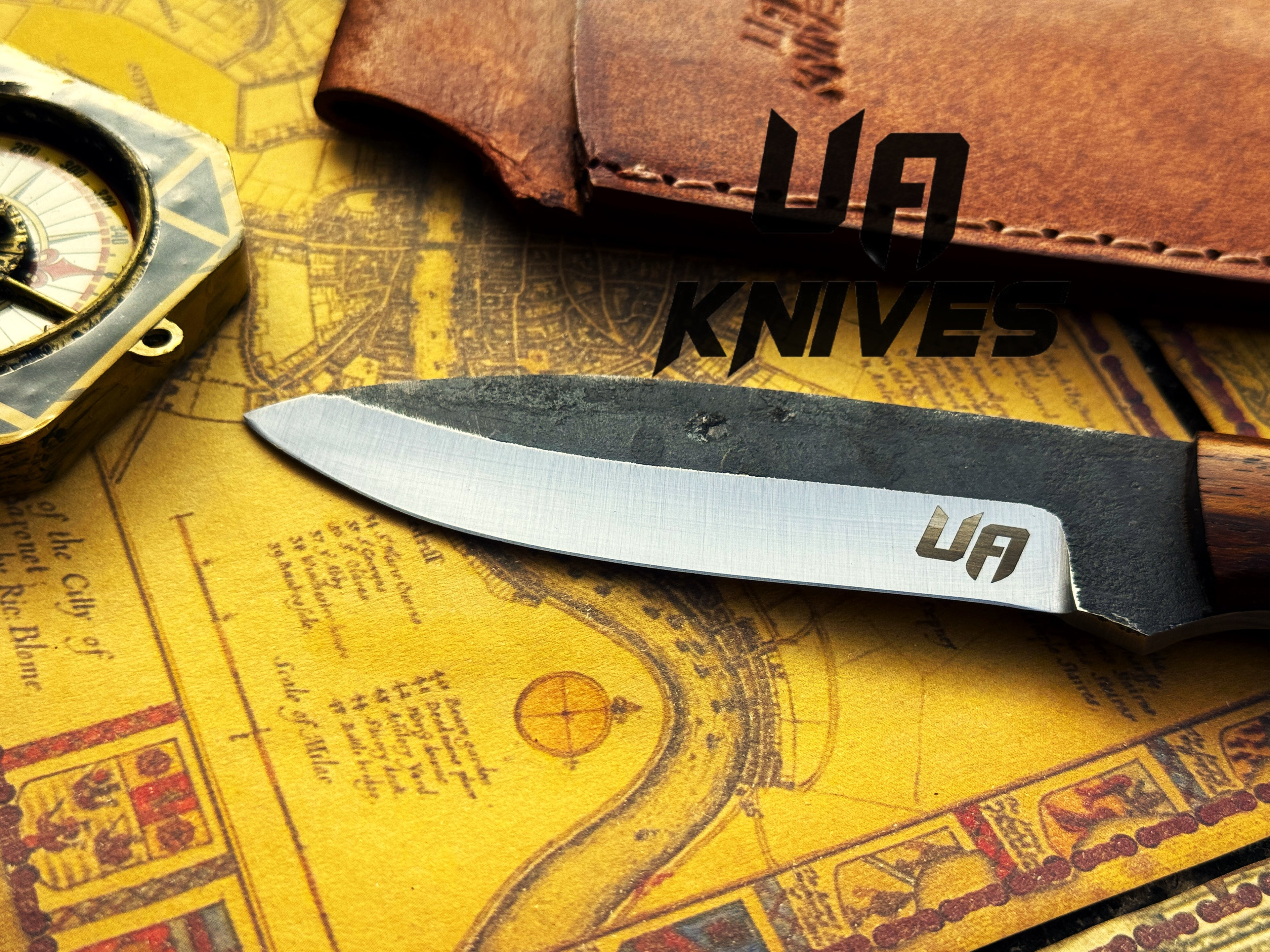UA Knives True Guide camping knife with hand-forged Scandinavian blade and ergonomic rosewood handle, ideal for bushcraft camping.