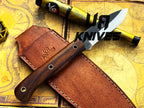 UA Knives True Guide camping knife with hand-forged Scandinavian blade and ergonomic rosewood handle for outdoor use.